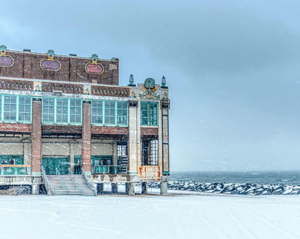 Asbury Park Convention Hall covered in snow along the beach during winter storm
Caption: