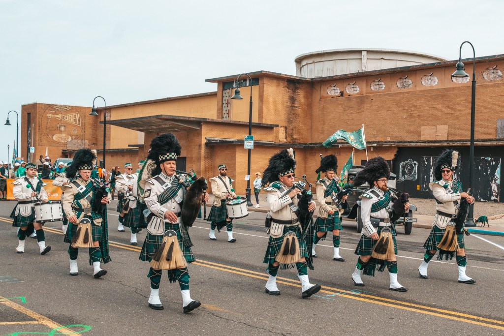 Asbury Park St Patrick's Day Parade bagpipers marching
Crowd celebrating St Patrick's Day parade Asbury Park NJ
Children waving flags at Asbury Park parade