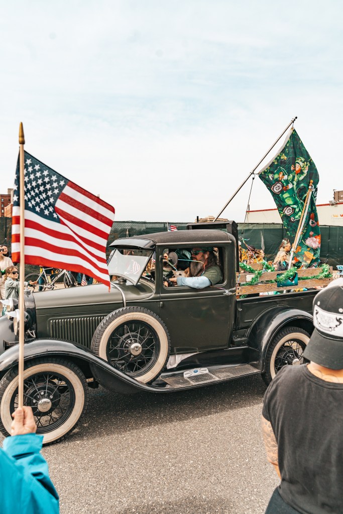 Asbury Park St Patrick's Day Parade bagpipers marching
Crowd celebrating St Patrick's Day parade Asbury Park NJ
Children waving flags at Asbury Park parade