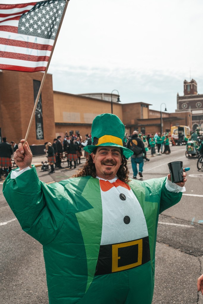 Asbury Park St Patrick's Day Parade bagpipers marching
Crowd celebrating St Patrick's Day parade Asbury Park NJ
Children waving flags at Asbury Park parade