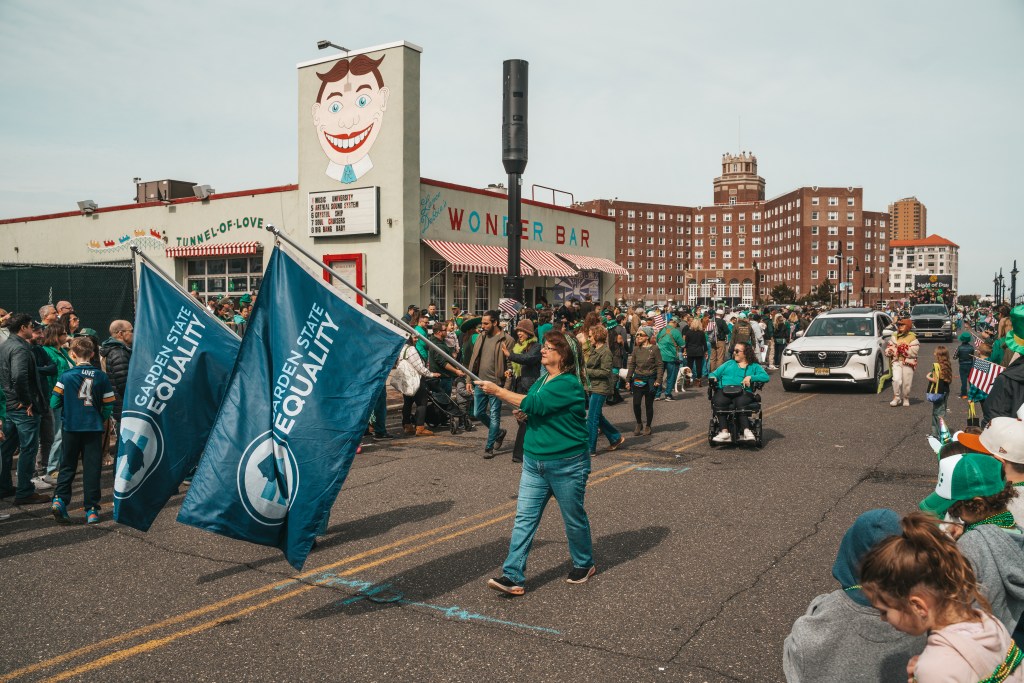 Asbury Park St Patrick's Day Parade bagpipers marching
Crowd celebrating St Patrick's Day parade Asbury Park NJ
Children waving flags at Asbury Park parade