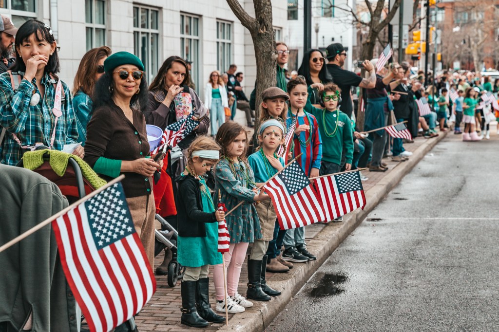 Asbury Park St Patrick's Day Parade bagpipers marching
Crowd celebrating St Patrick's Day parade Asbury Park NJ
Children waving flags at Asbury Park parade