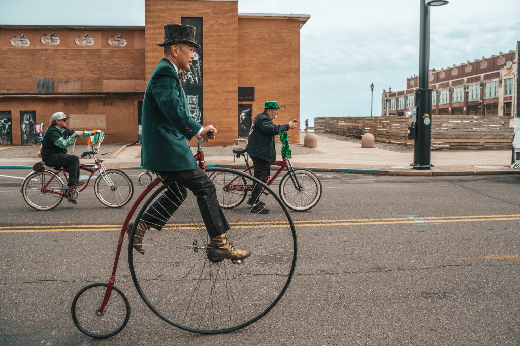 Asbury Park St Patrick's Day Parade bagpipers marching
Crowd celebrating St Patrick's Day parade Asbury Park NJ
Children waving flags at Asbury Park parade