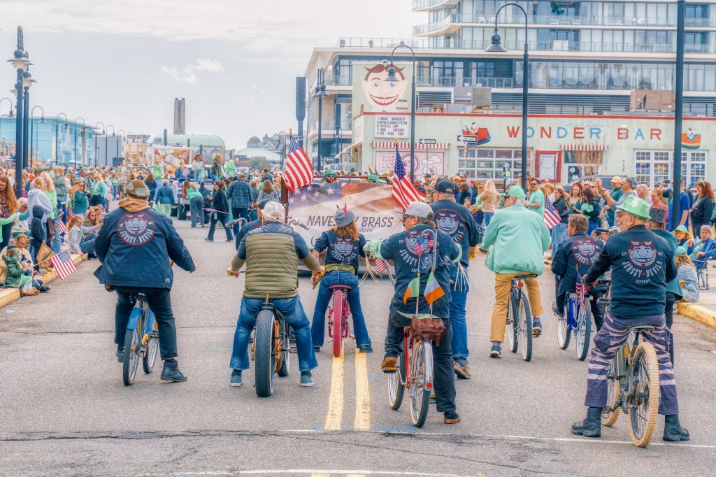 Asbury Park St Patrick's Day Parade bagpipers marching
Crowd celebrating St Patrick's Day parade Asbury Park NJ
Children waving flags at Asbury Park parade