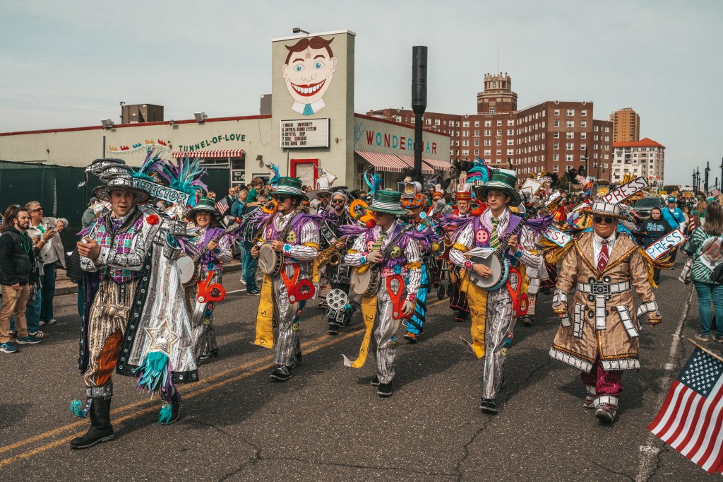 Asbury Park St Patrick's Day Parade bagpipers marching
Crowd celebrating St Patrick's Day parade Asbury Park NJ
Children waving flags at Asbury Park parade