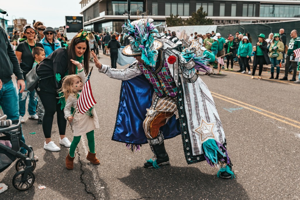 Asbury Park St Patrick's Day Parade bagpipers marching
Crowd celebrating St Patrick's Day parade Asbury Park NJ
Children waving flags at Asbury Park parade